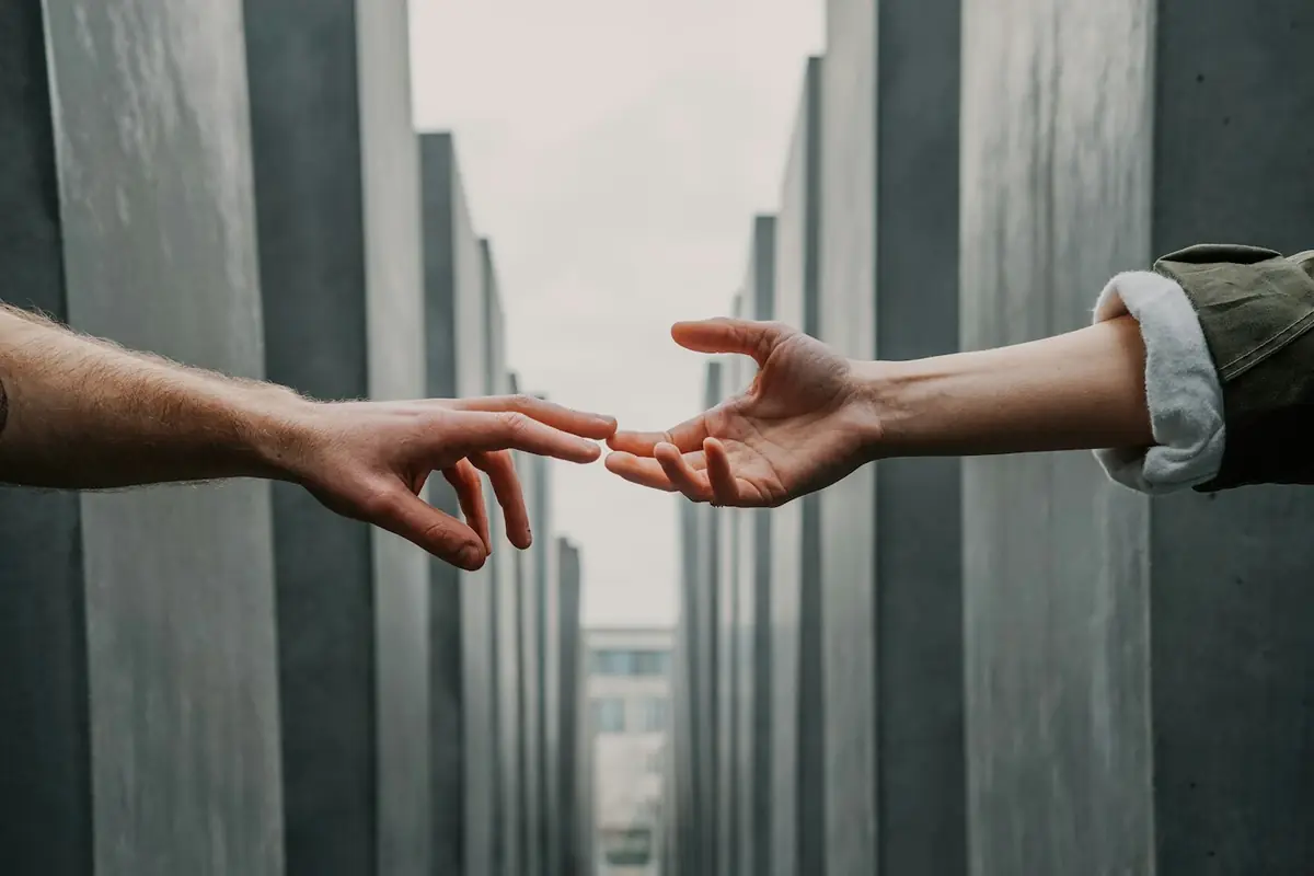 Two hands reaching toward each other in support