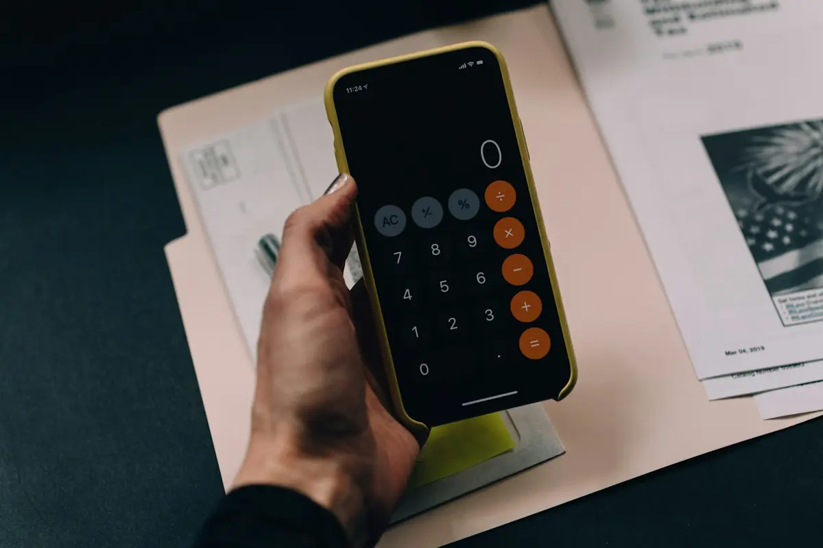 Business owner reviewing figures on a calculator