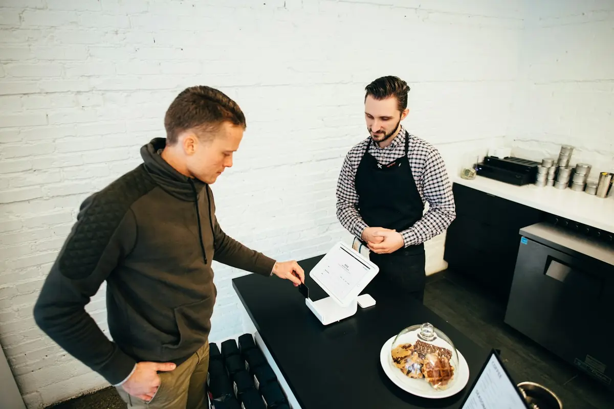 Small business owner talking with a customer at the counter